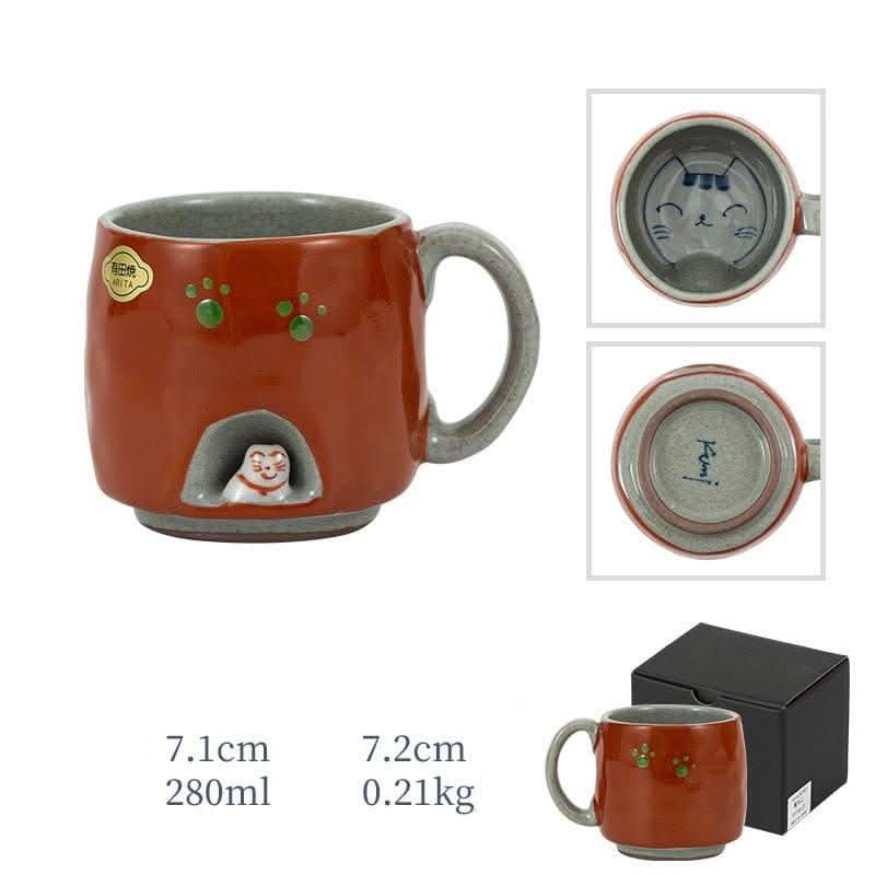 Japan imports Arita ware hand-made cat mug in orange with green paw prints and a tiny cat.