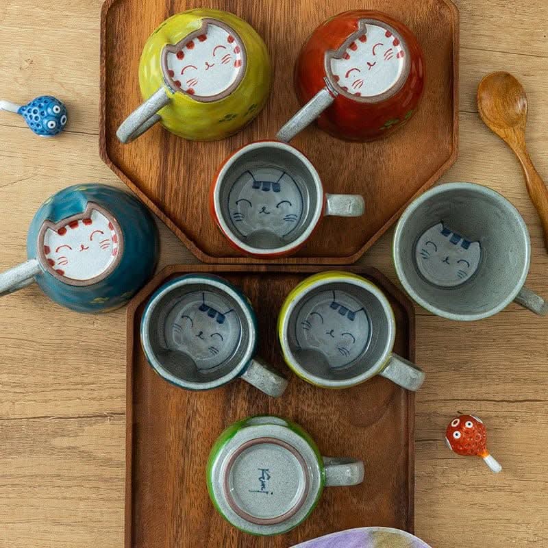 Japan imports Arita ware hand-made cat mugs in various colors with cute cat faces.