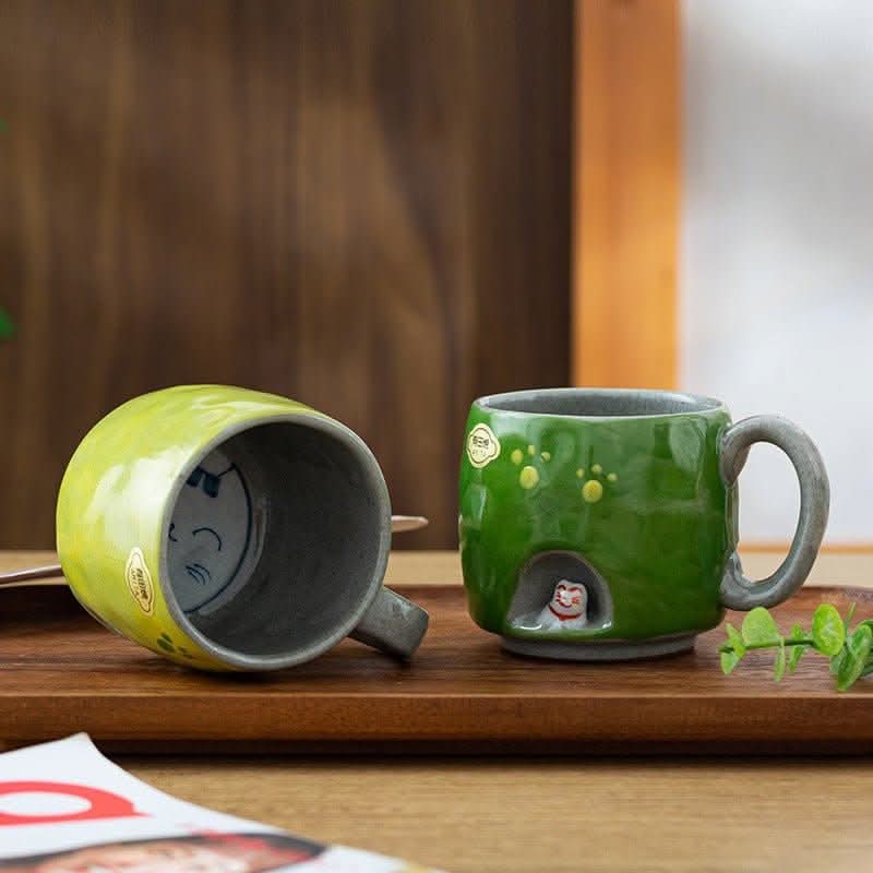 Japan imports Arita ware hand-made cat mug in green, featuring paw prints & a hidden cat.