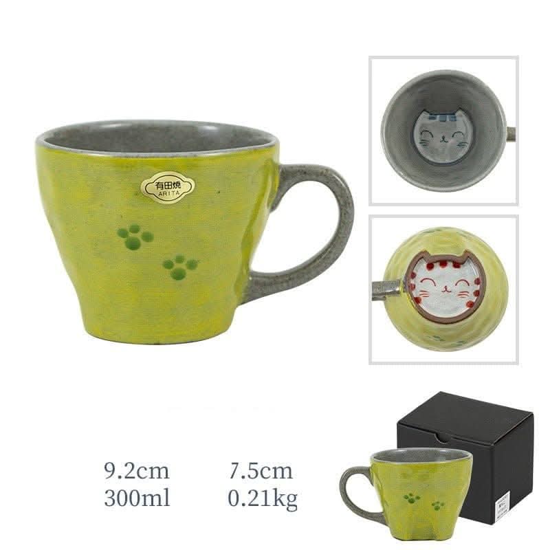 Hand-made Arita ware cat mug, lime green with paw prints. Features cute cat face inside.