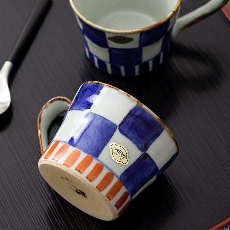 Japan imports Arita ware hand-painted blue & white checkered mug with orange accents.