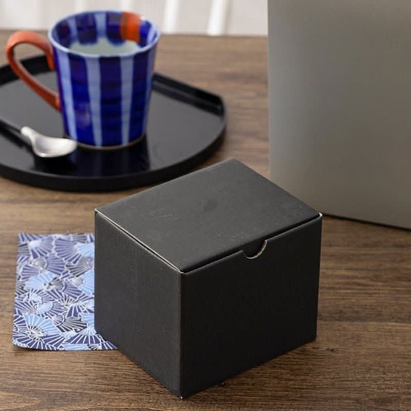 Japan Imports Arita ware hand-painted blue & white mug with orange handle.