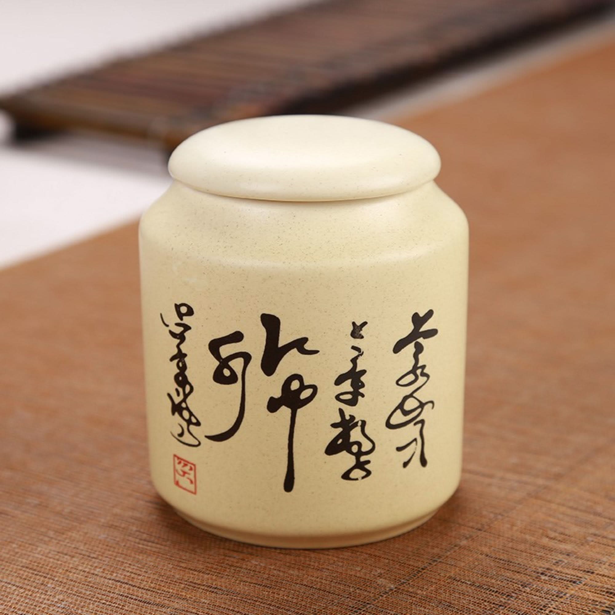 Japanese art ceramic tea container with calligraphy. Light yellow storage jar.