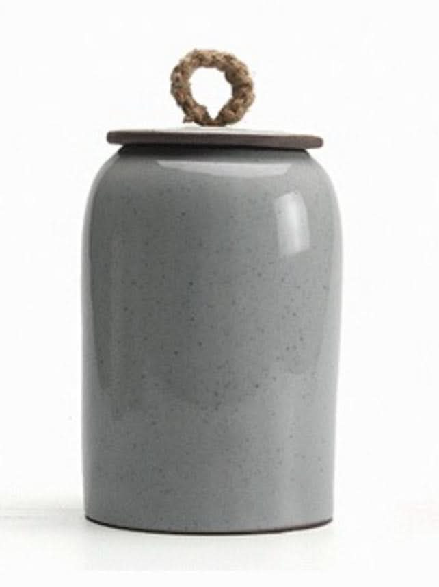 Gray ceramic tea canister with rope handle lid. Storage jar for tea, coffee, sugar.