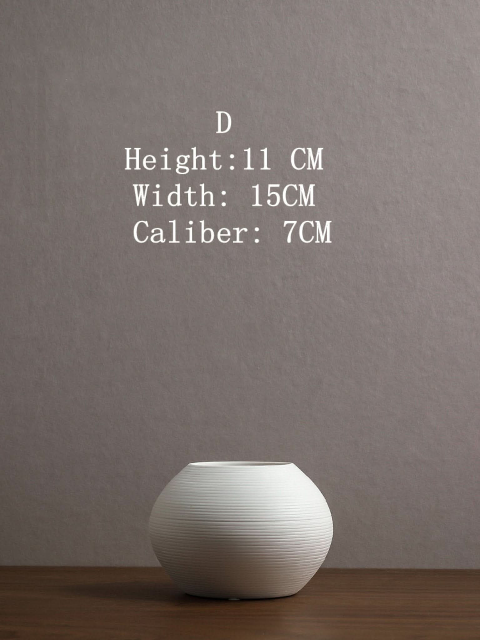 Japanese ceramic vase, white, ribbed minimalist design on wooden surface.