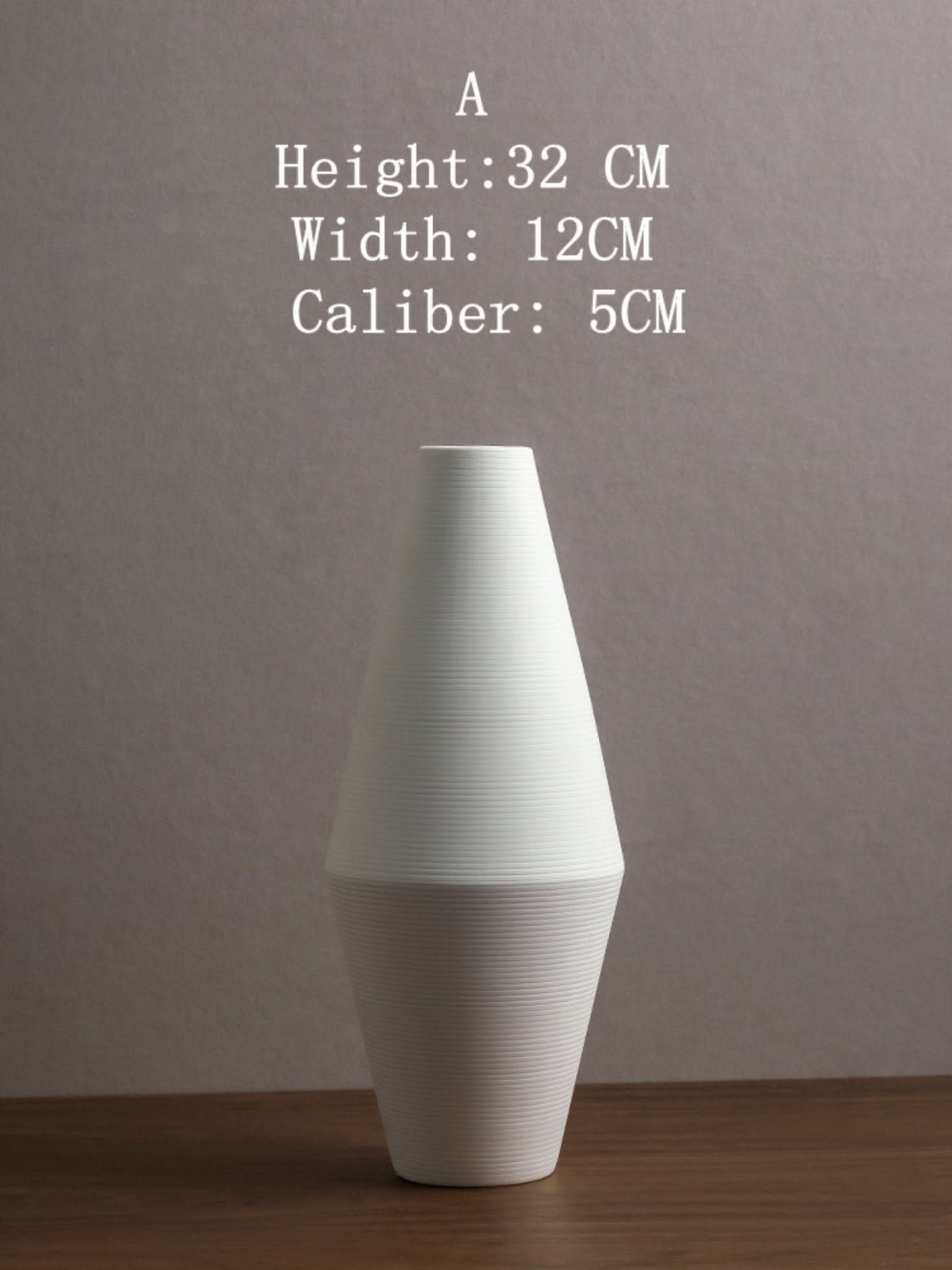 Japanese ceramic vase, white minimalist ceramic vase on wooden table.