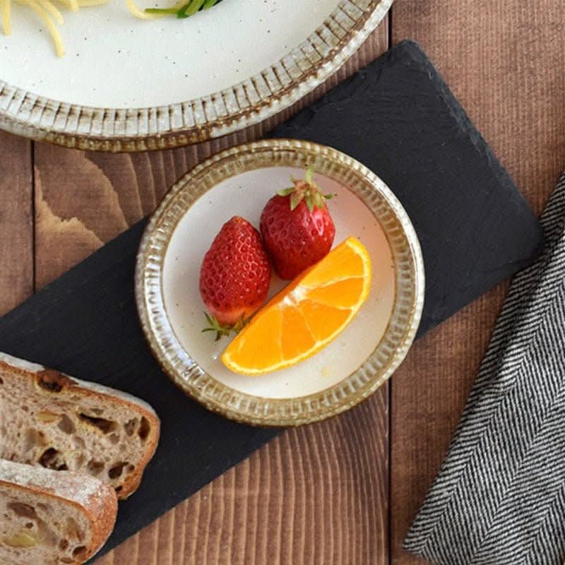 Japanese Tableware Handmade Set: cream ceramic bowl with strawberries, orange slice, bread, and cloth.
