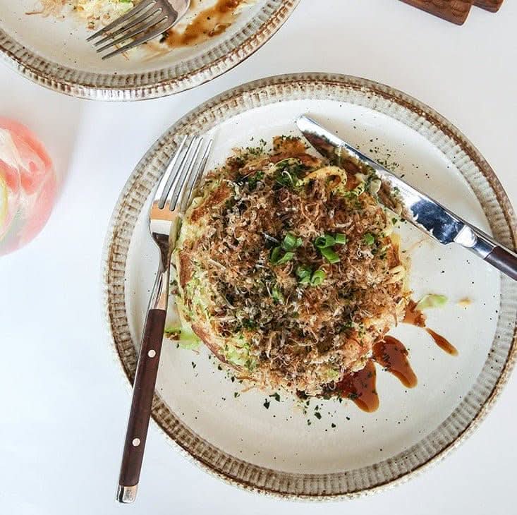 Japanese Tableware Handmade Set: ceramic plates with intricate rustic rim, serving okonomiyaki.
