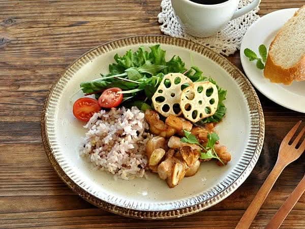 Japanese Tableware Handmade Set: Cream plate with rice, salad, lotus root, and tomatoes, served on wood.