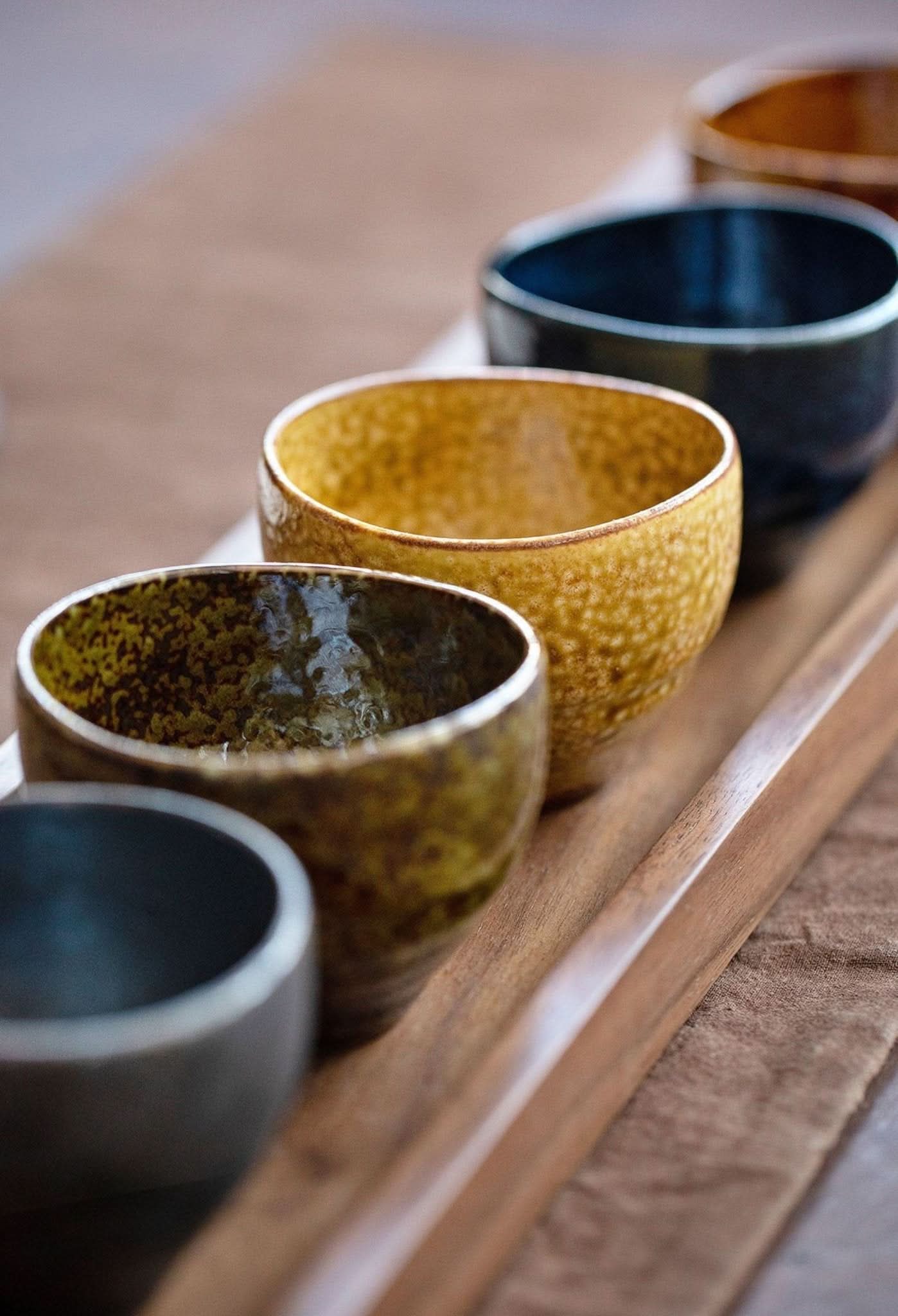 Japanese-Imported Glazed Tea Cup 5 Set: Rustic ceramic bowls in earth tones on wooden tray.
