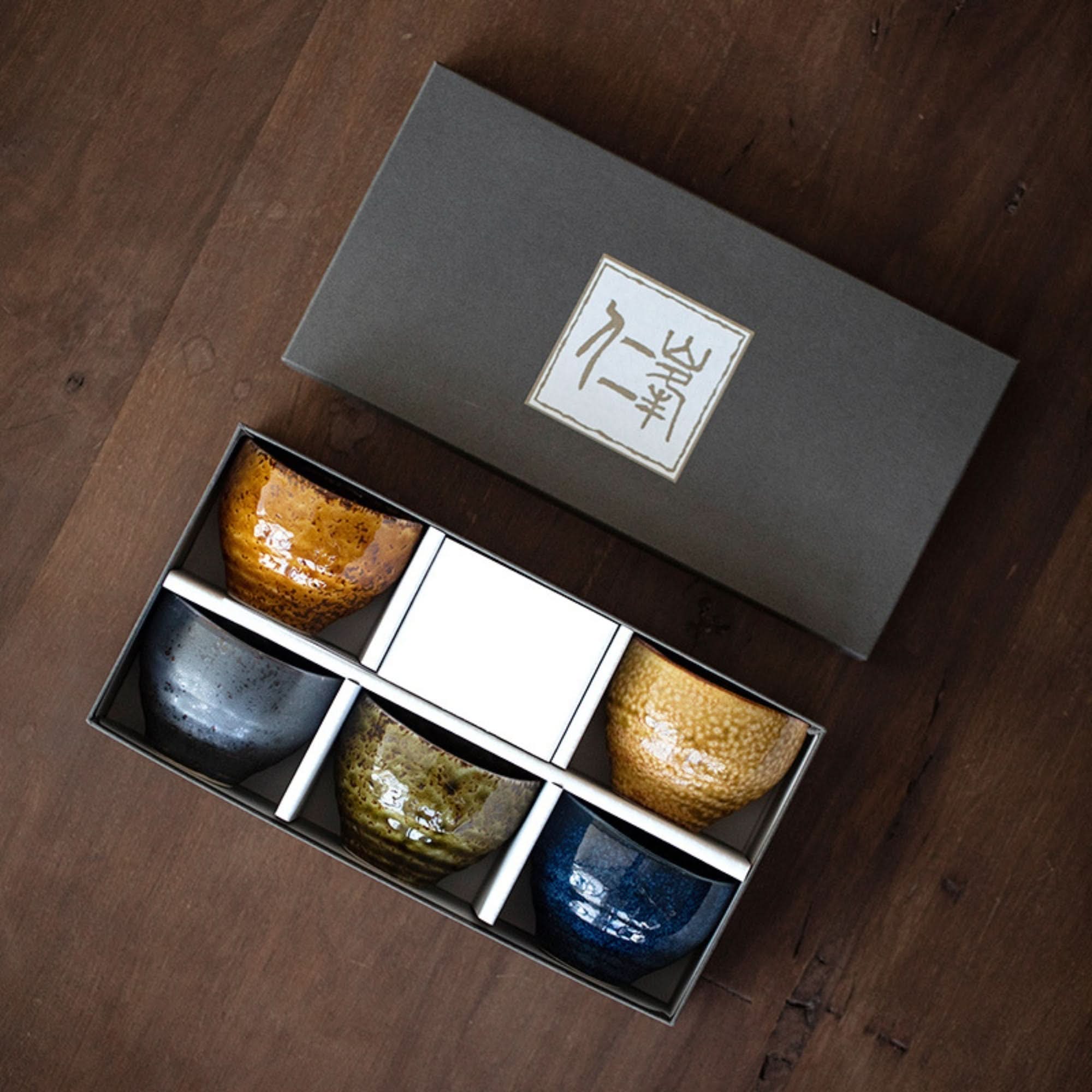Japanese-Imported Glazed Tea Cup 5 Set: Ceramic tea ceremony cups in a gift box on wood.
