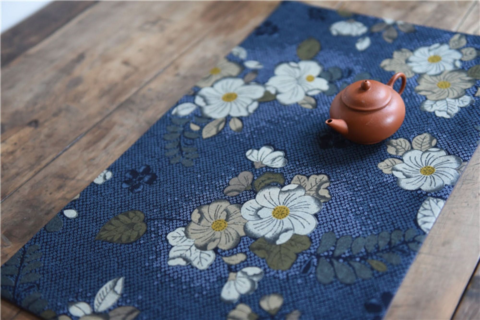 Japanese linen tea towels with floral patterns in blue, featuring a tiny teapot.