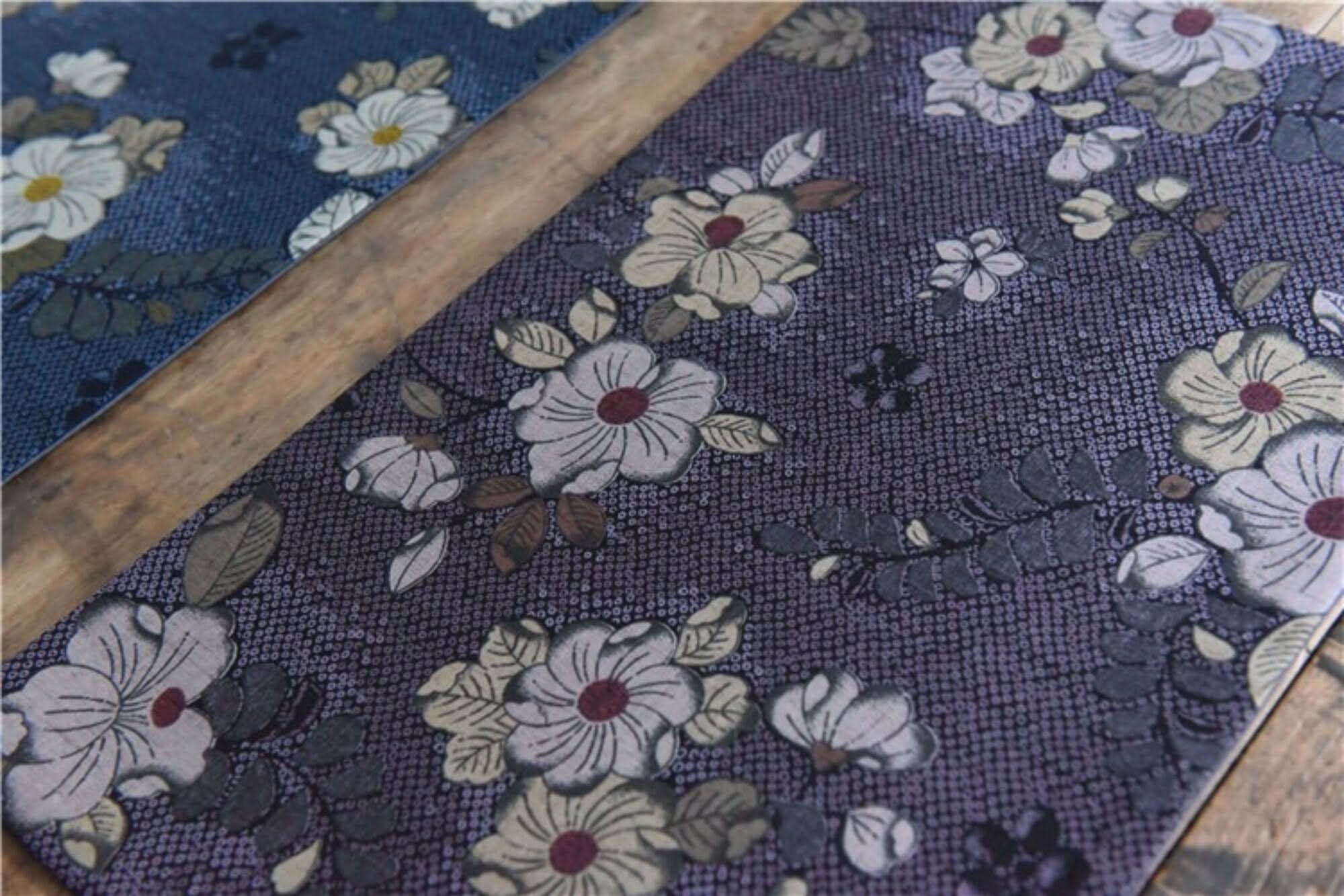 Japanese linen tea towels with floral patterns in purple and blue hues, inspired by cherry blossoms.