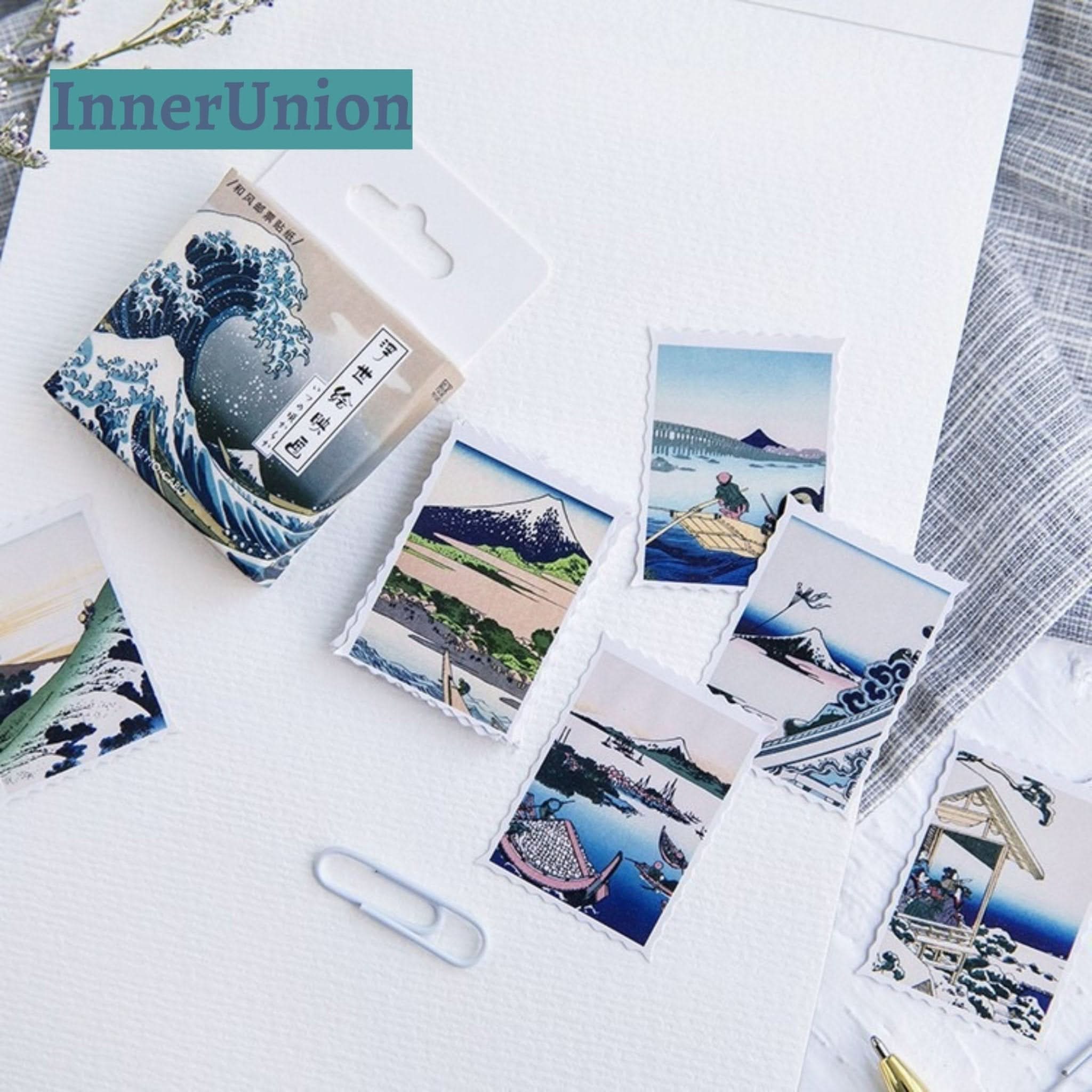 Japanese Postcards Stickers showcase Hokusai's art with blue, green, and pink hues on paper.