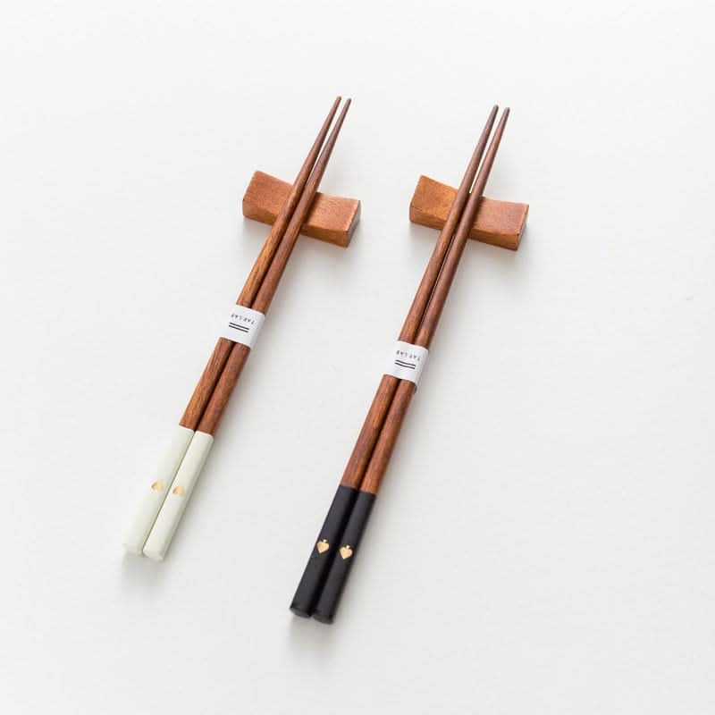 Japanese Solid Wood Peach Heart Chopsticks: white & black, gold heart detail, wood stands.