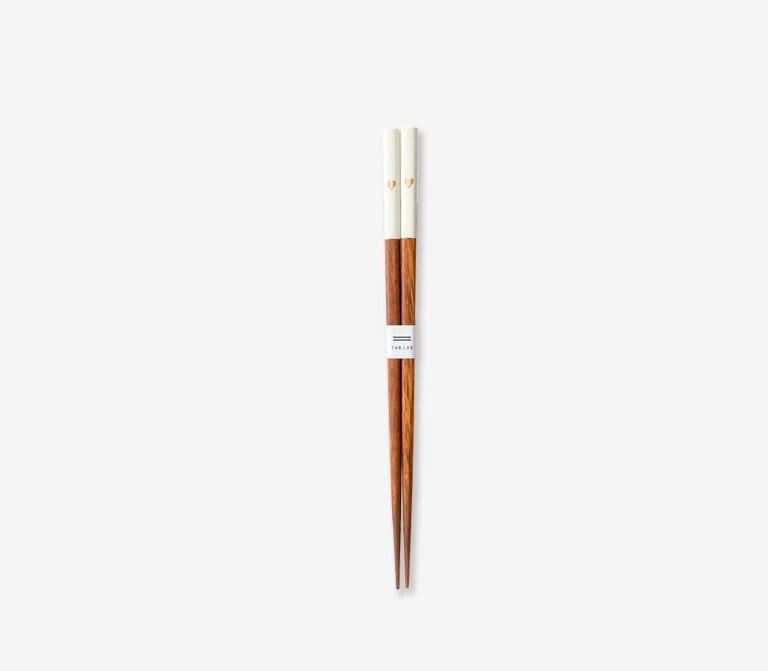 Japanese solid wood peach heart chopsticks, white-tipped, on a white background.