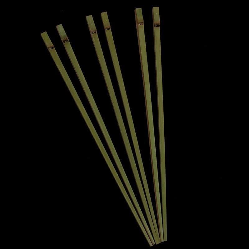 Natural bamboo Japanese style chopsticks arranged on a black background.