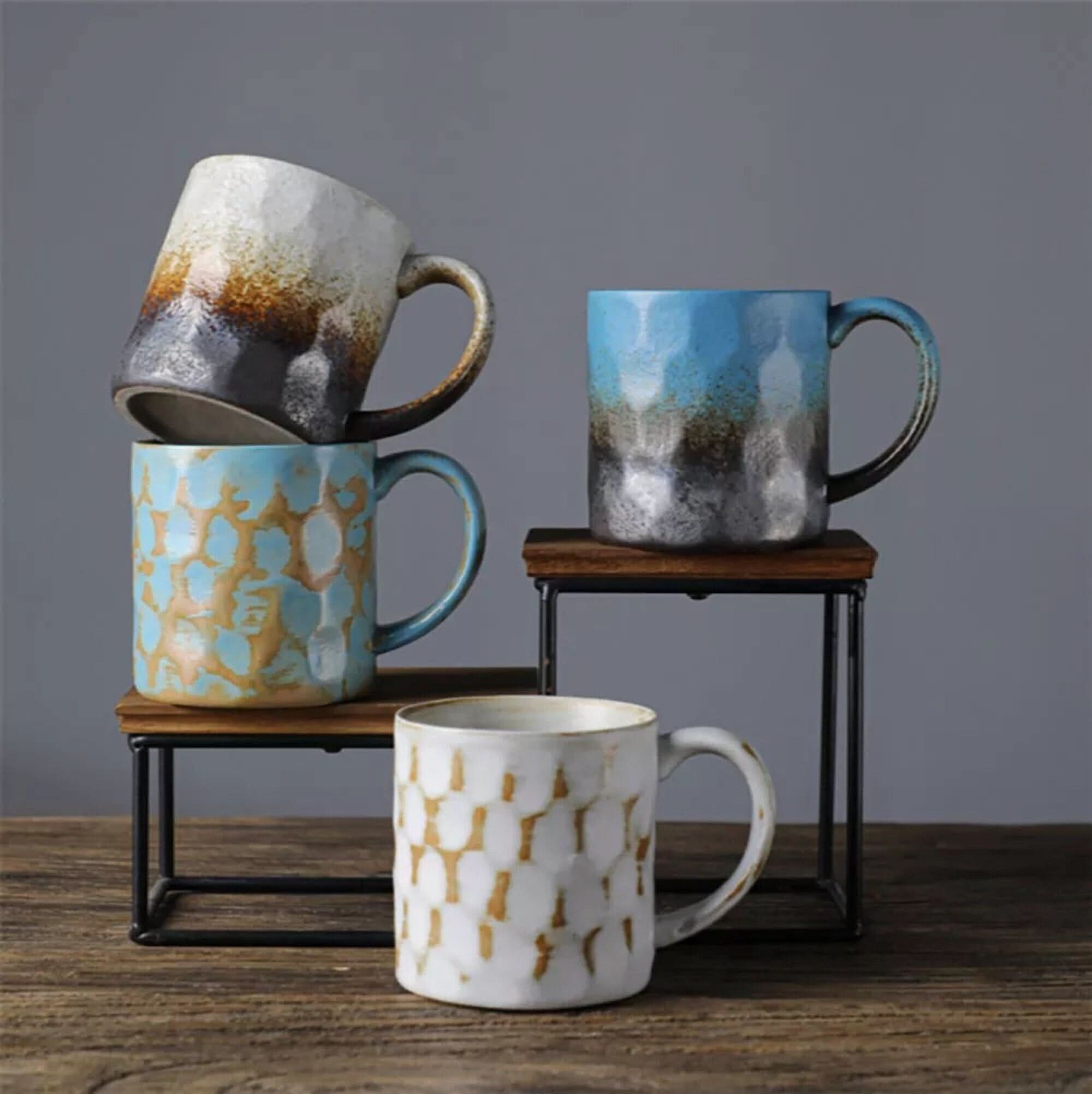 Japanese style ceramic coffee cup retro mug in blue, white, and earth tones. Textured finish.