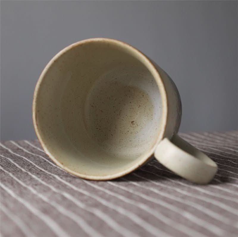 Japanese Style Ceramic Coffee Cup Retro Mug, speckled beige ceramic, on striped cloth