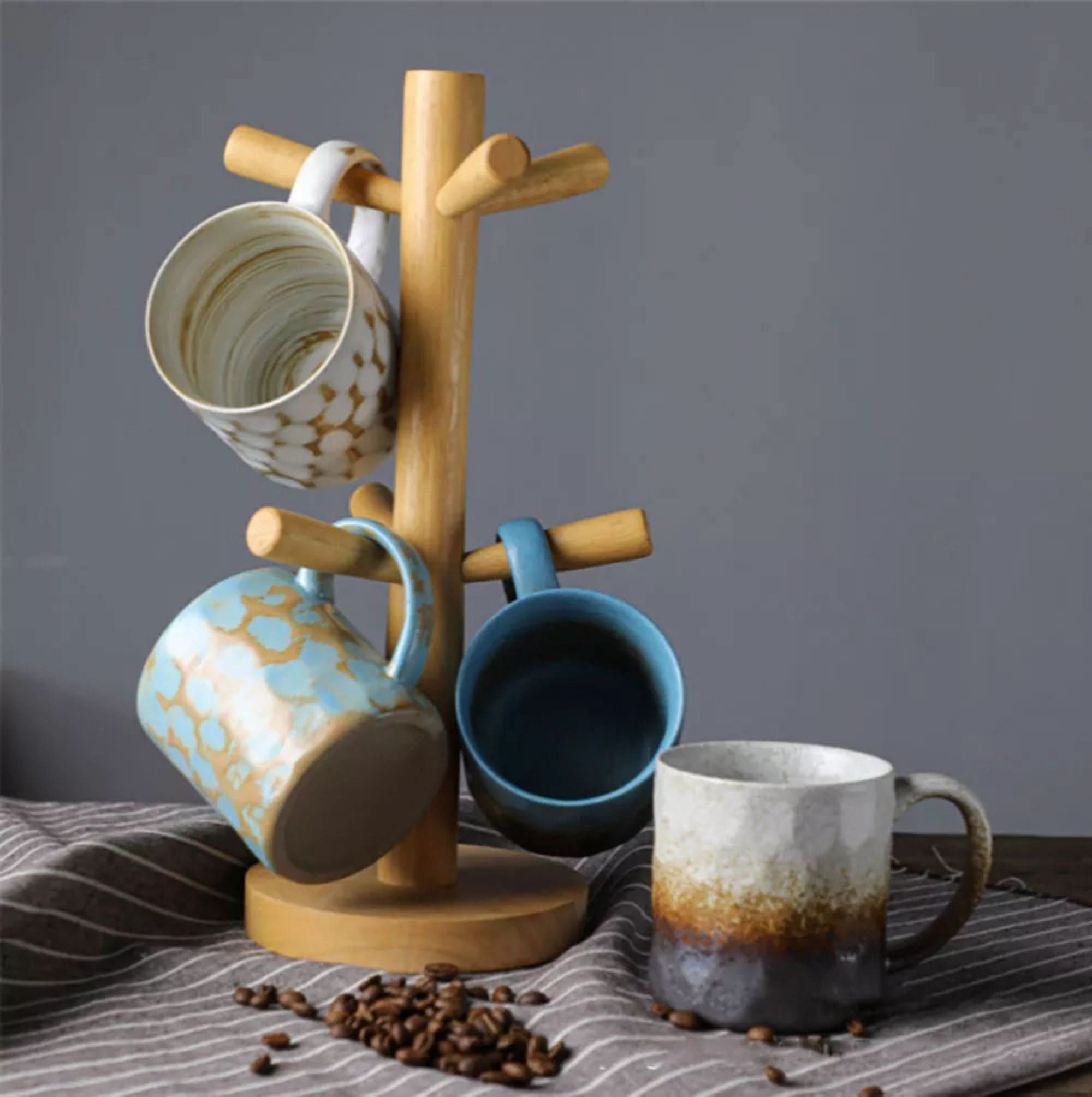 Japanese style ceramic coffee cup retro mug with ombre glaze on a wooden stand.