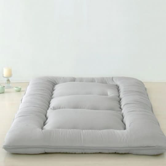 Muted gray Japanese Futon Mattress featuring a unique quilted channel pattern in a soft cotton-polyester blend fabric.
