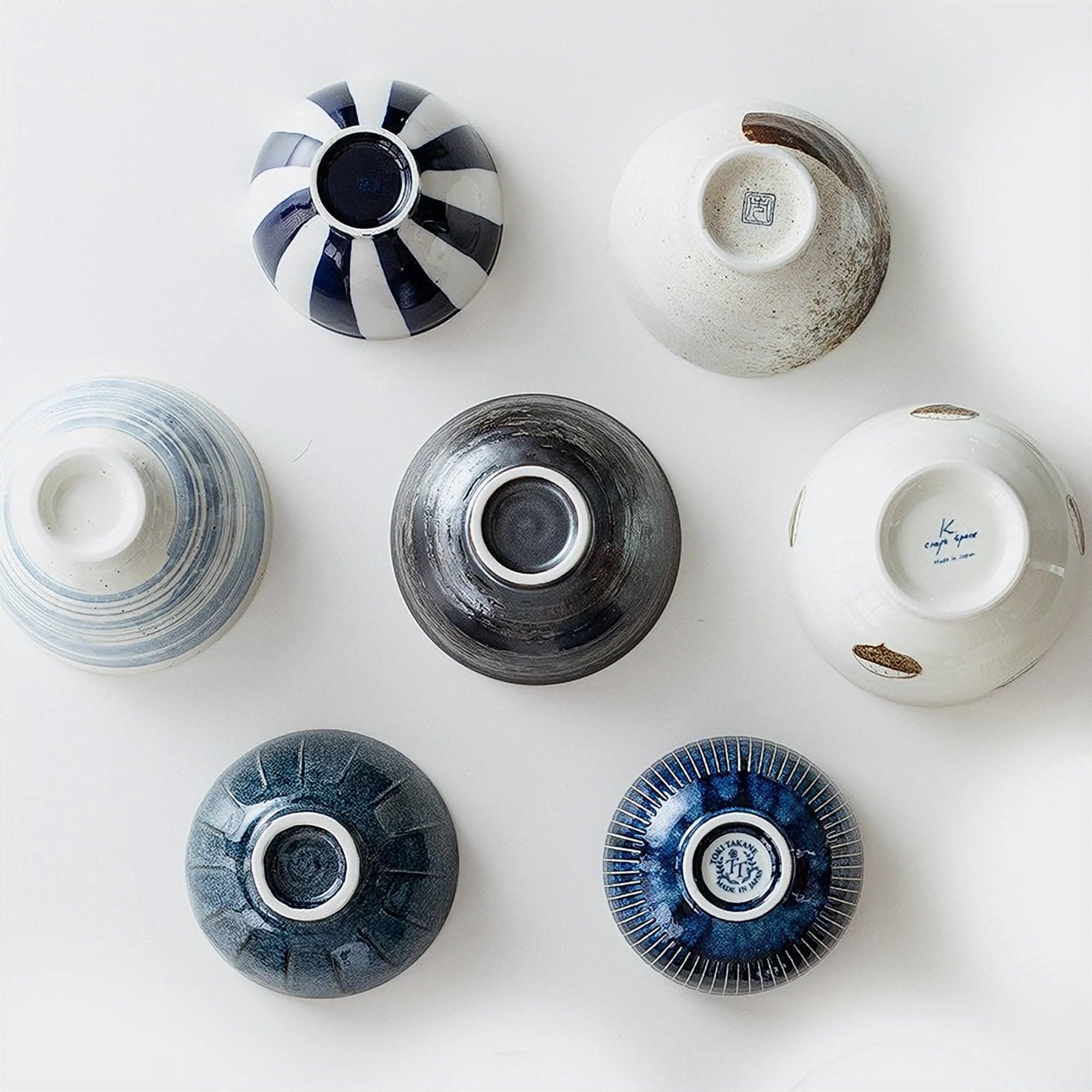 Japanese Minoyaki ceramic bowls: striped, speckled, and textured designs on white background.