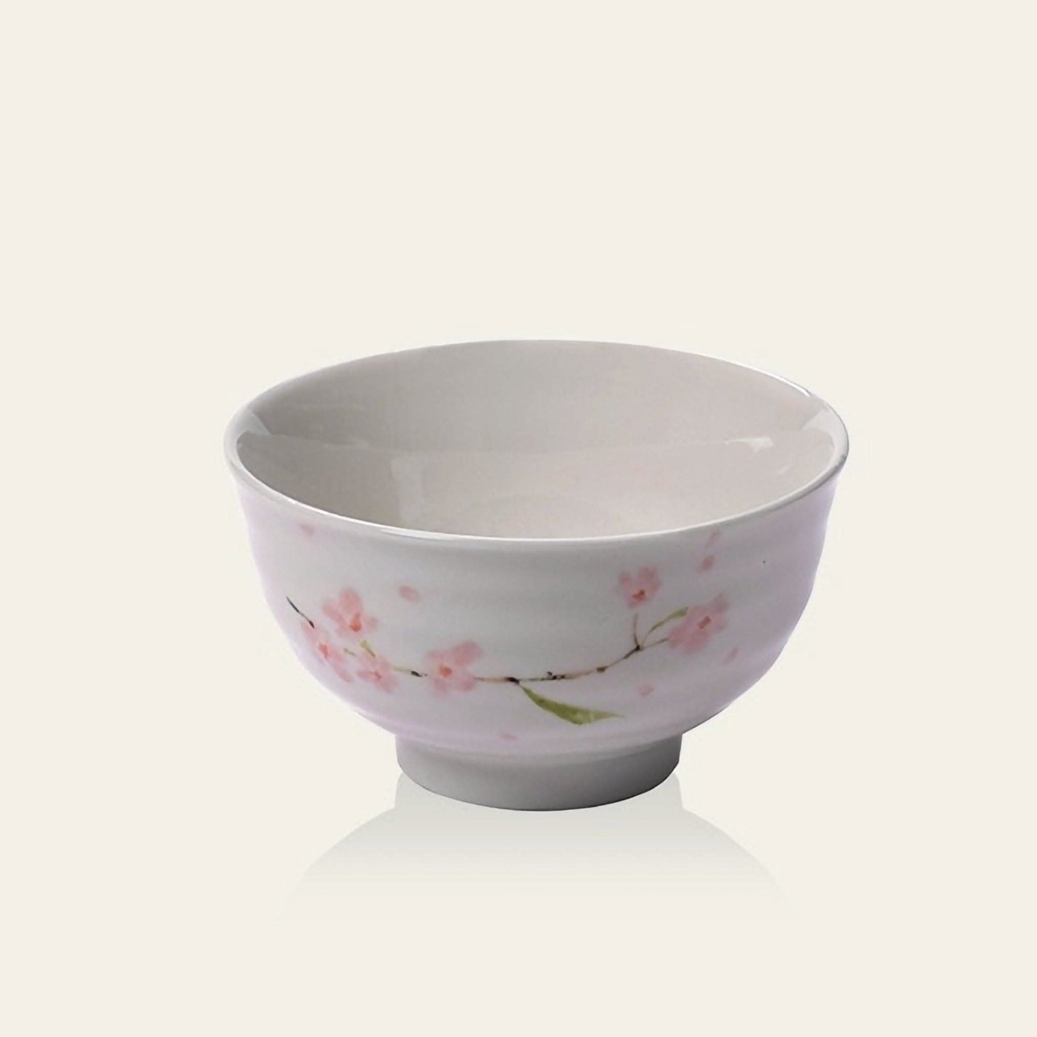 White ceramic Minoyaki rice bowl with pink cherry blossoms.