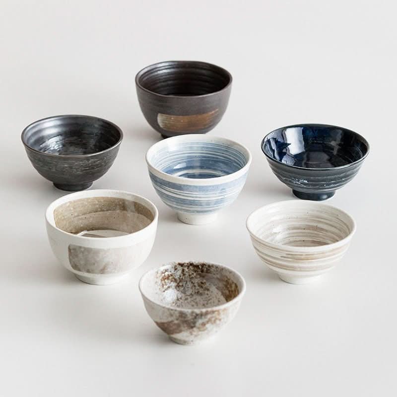 Japanese Minoyaki bowls in assorted colors and textures on a white background.