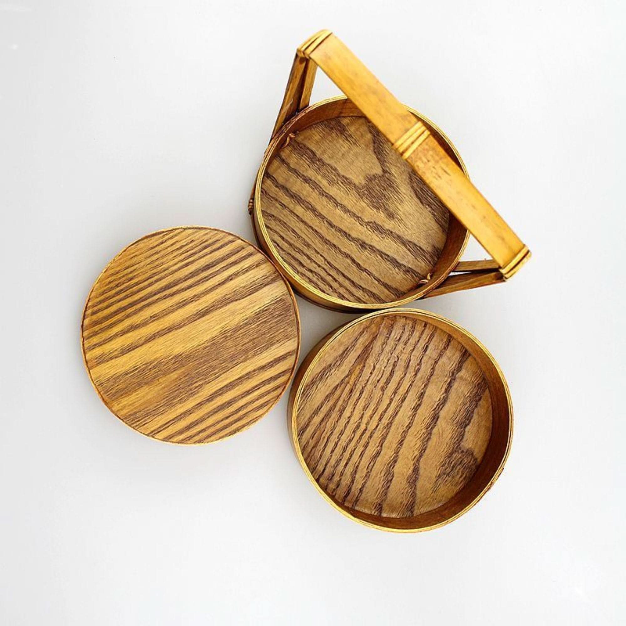 Natural wood Japanese lunch box with bamboo handle on white background