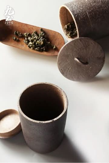 Japanese Style Raw Rustic Tea Jar, textured ceramic, with loose tea leaves.