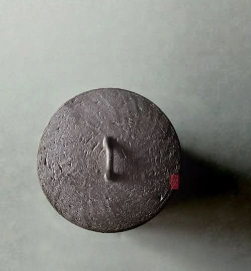 Japanese Style Raw Rustic Tea Jar lid, dark grey textured ceramic with handle.