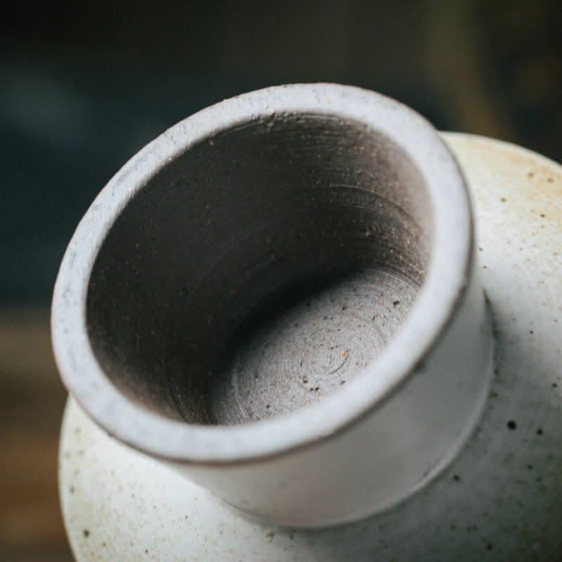 Close-up of Japanese Style Stoneware Fruit Plate, off-white with speckled texture.
