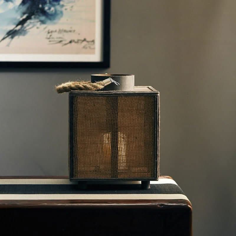 Rustic Coastal Candle Holders: natural woven lantern with rope accent on dark wood table.