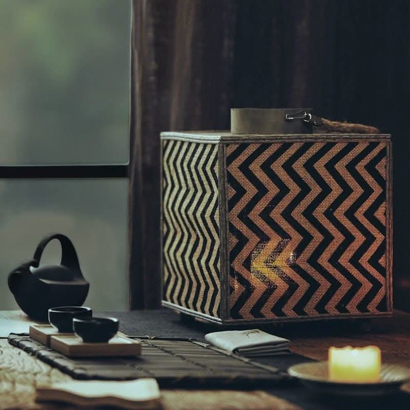 Coastal candle holder with chevron pattern, natural materials, cast iron teapot and tea set.