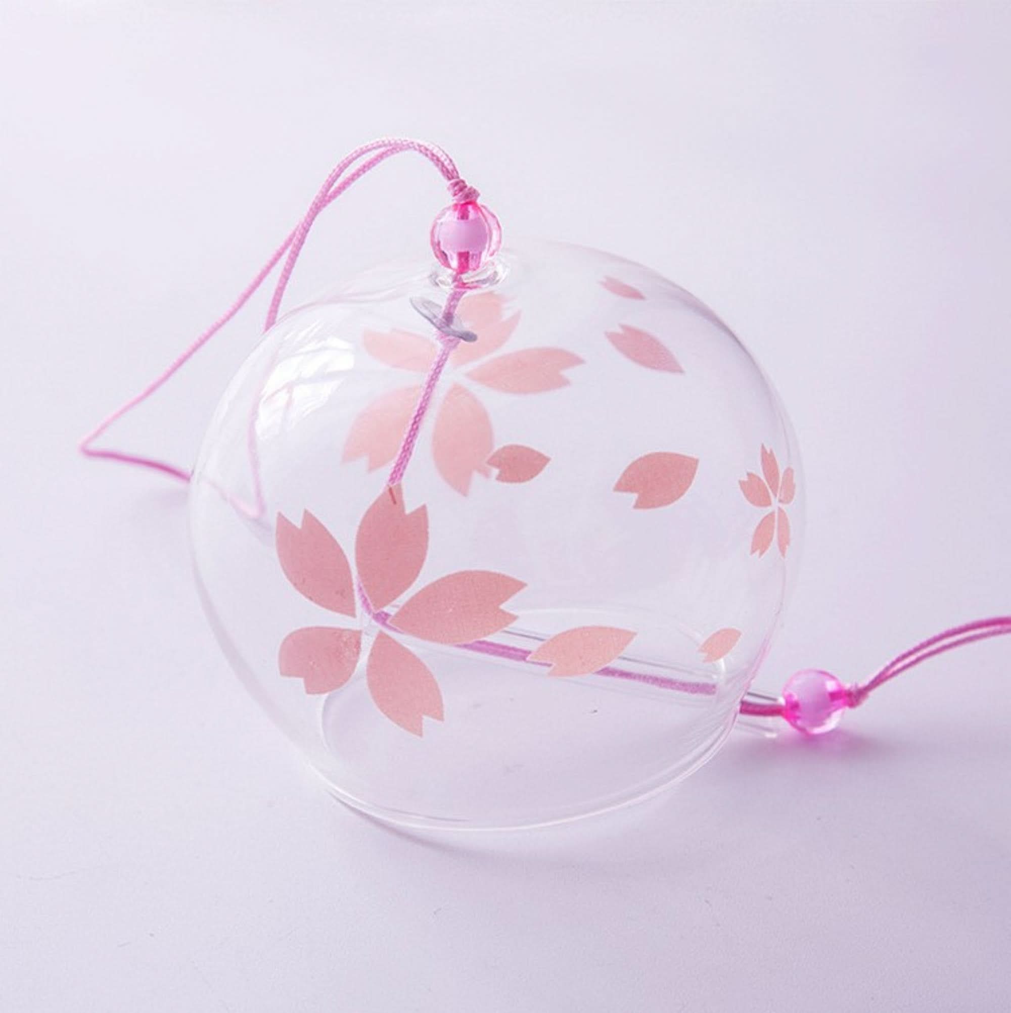 Clear glass Japanese wind chime with pink cherry blossoms and hanging cord.