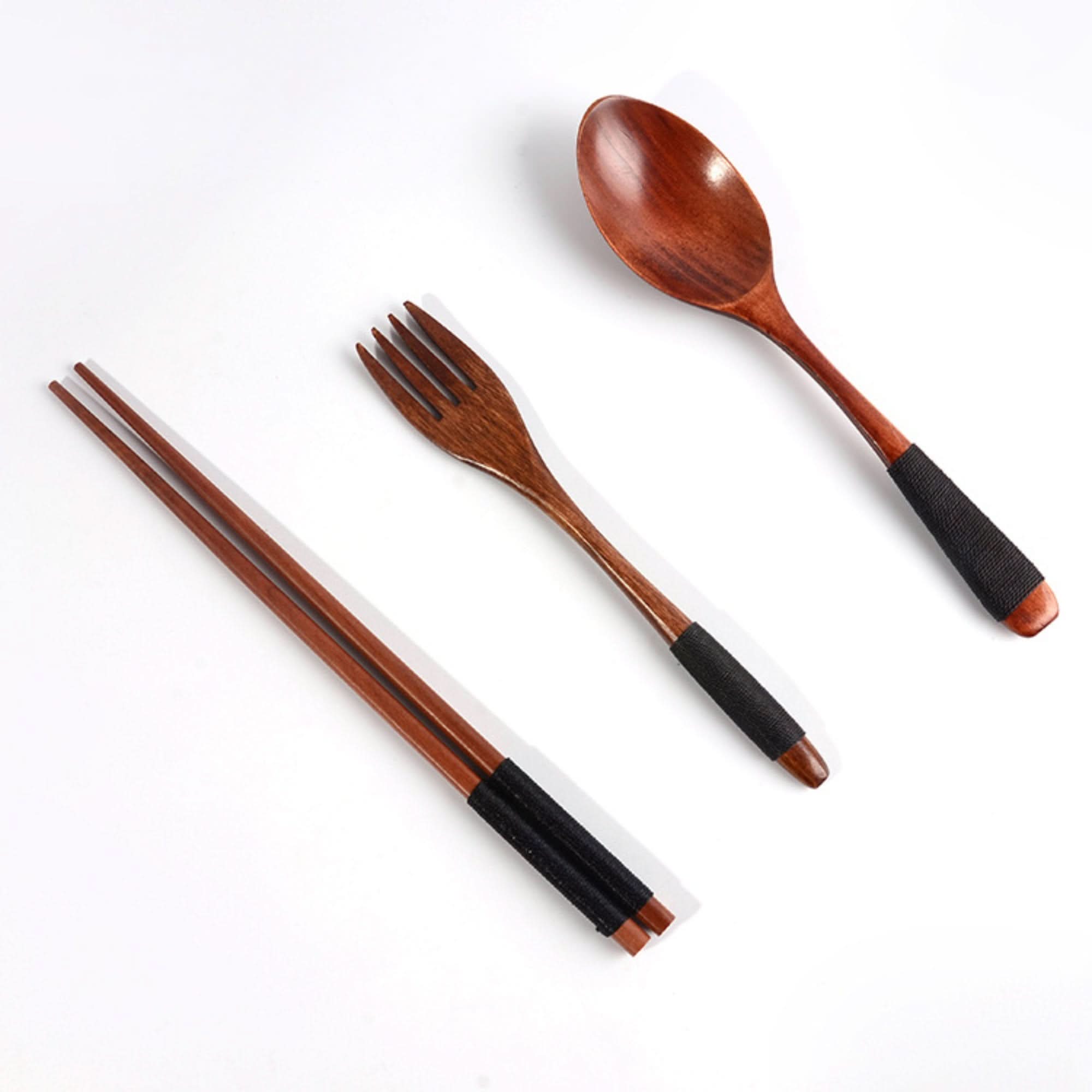 Natural wooden Japanese cooking utensils: chopsticks, fork, and spoon with black accents.