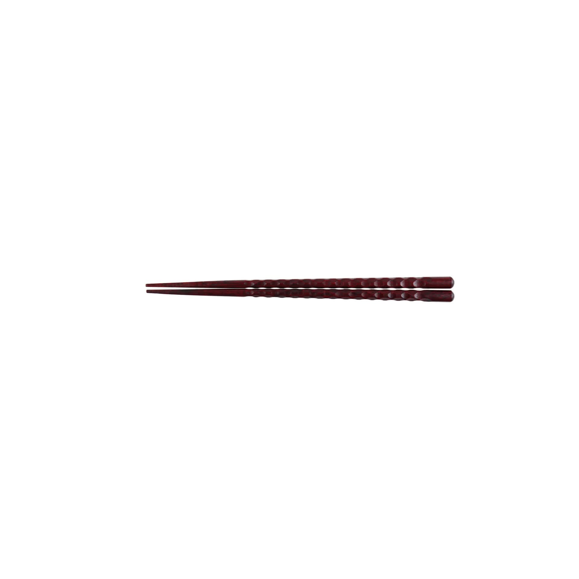 Dark red Japanese wooden chopsticks with carved texture, perfect for dining.