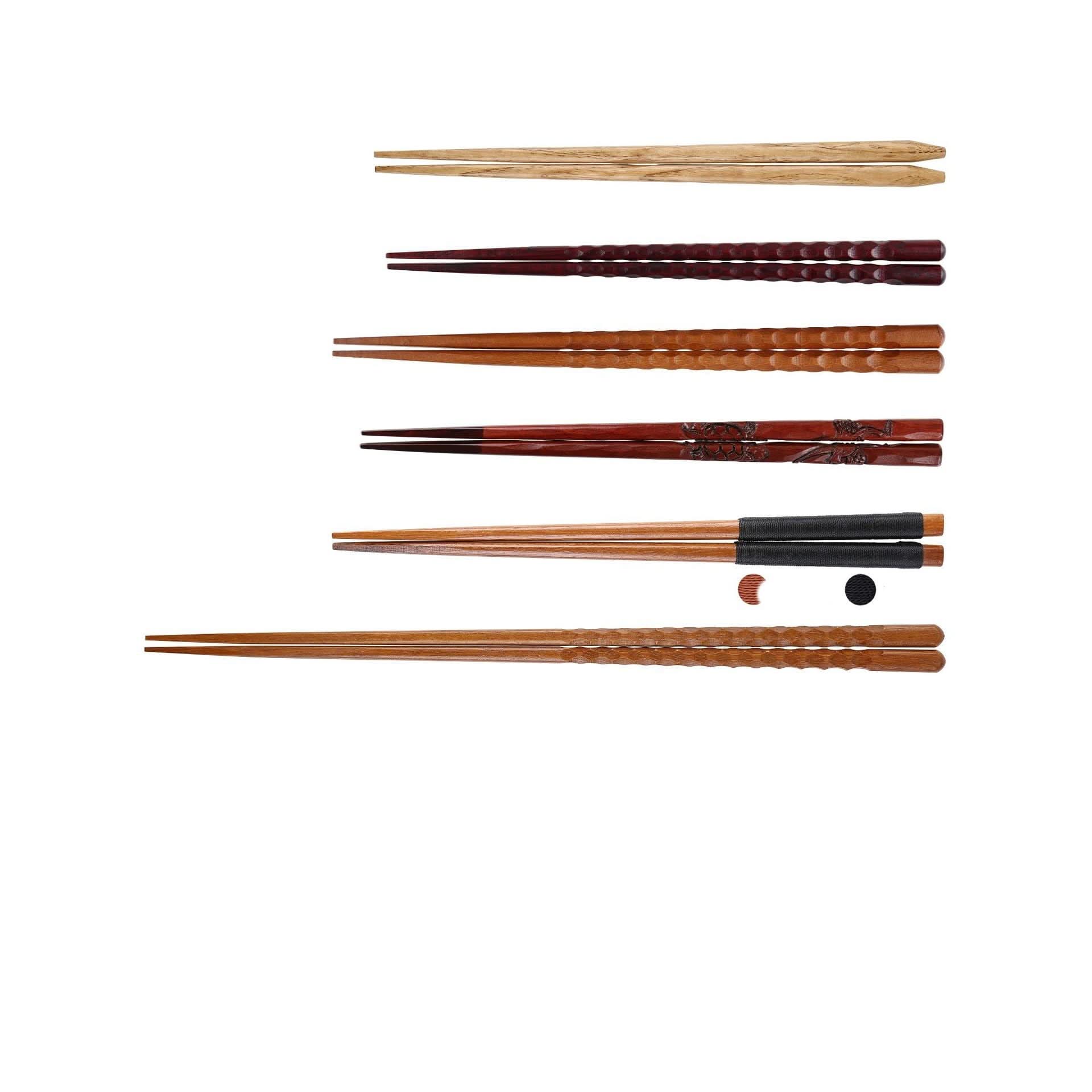 Assortment of Japanese wooden chopsticks with carvings and colors, including a spoon set.