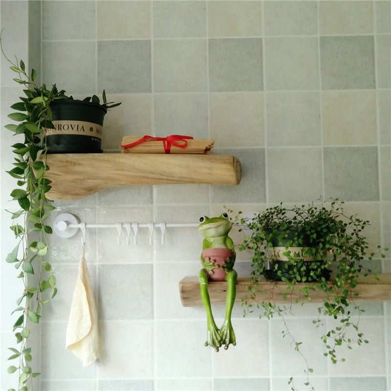 Log Live Edge Wall Hanging Shelves with plants, frog decor, and towel on tiled wall