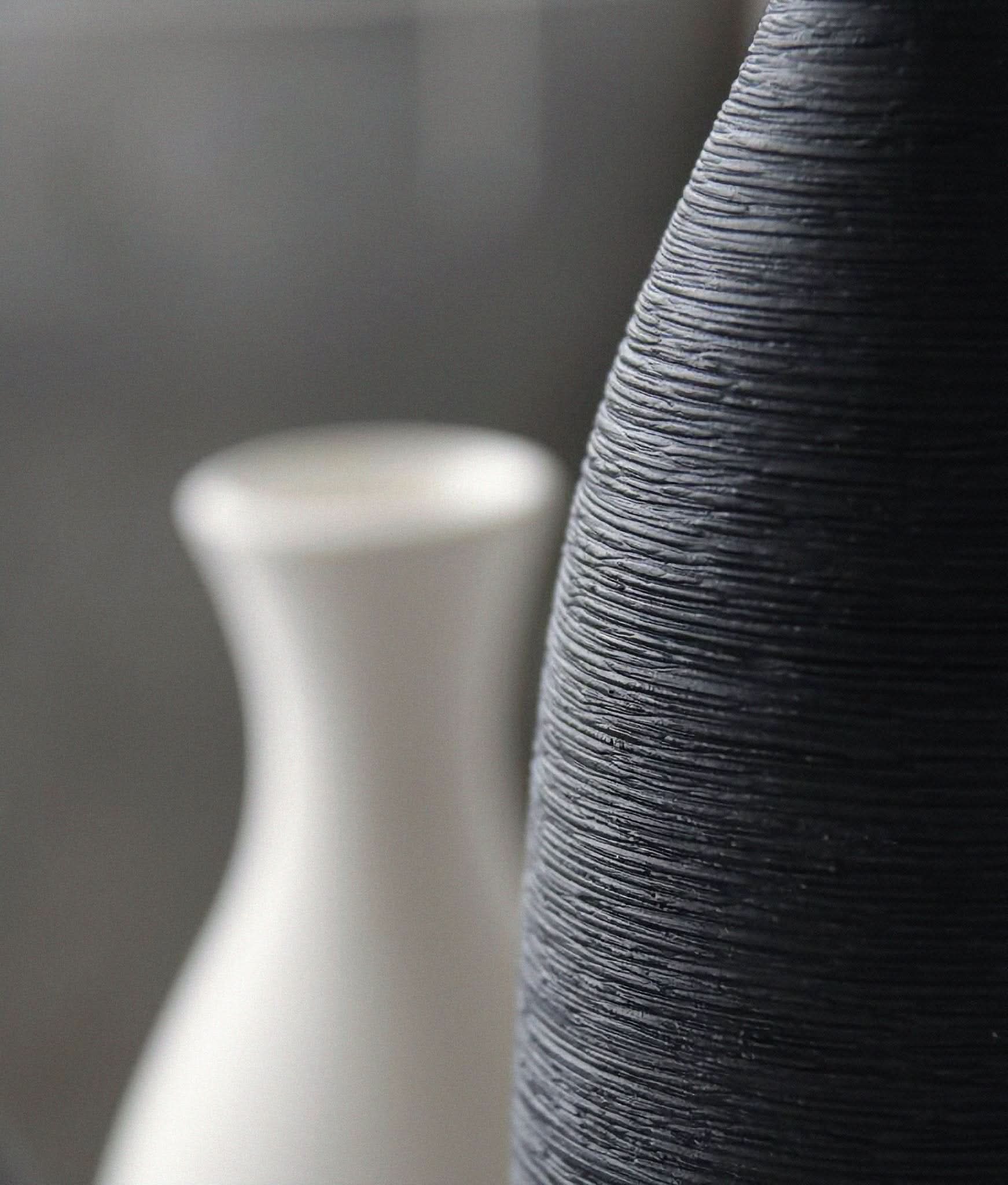 Minimalist ceramic vase in black and white, textured stoneware, modern zen decor.