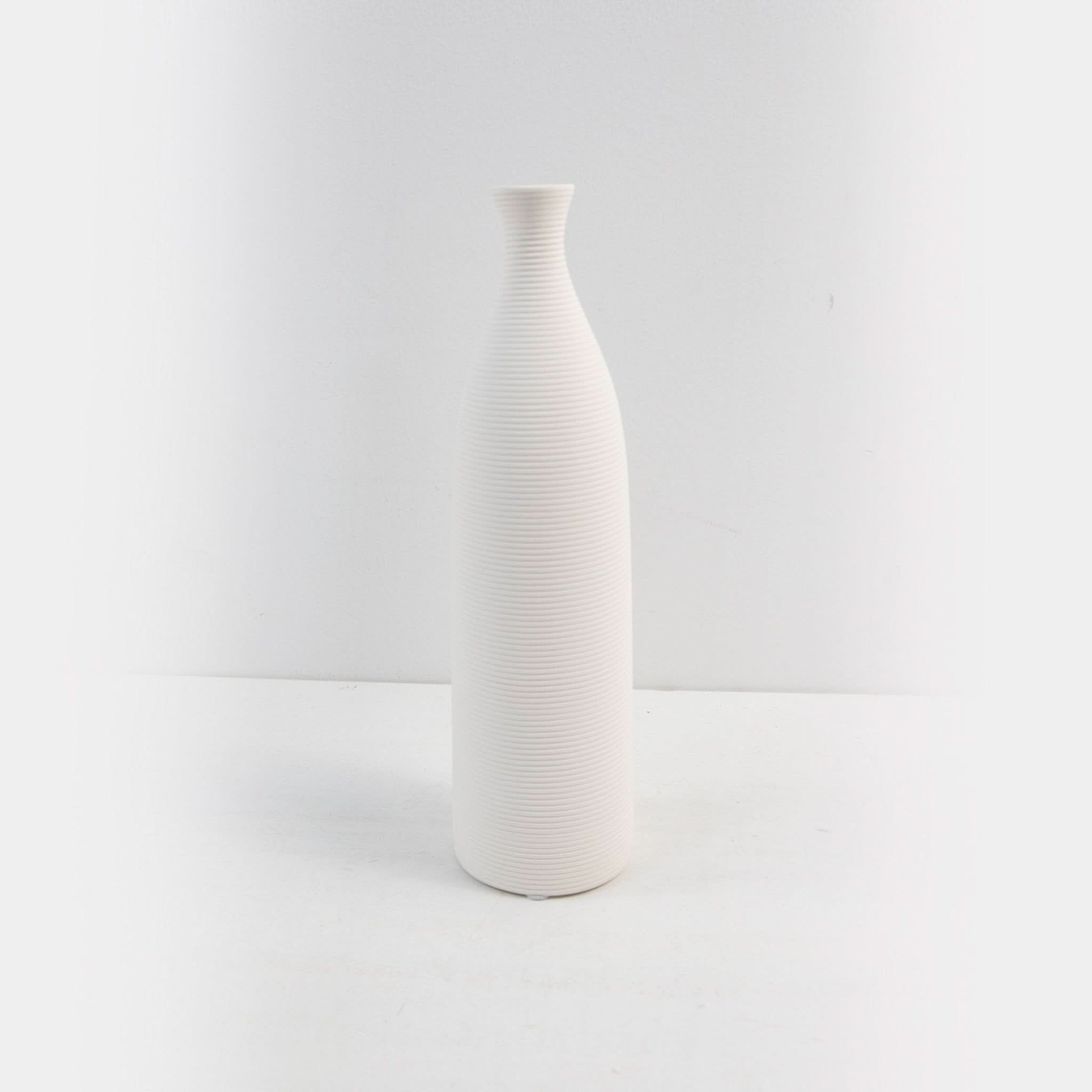 Minimalist white ceramic vase with ribbed texture, modern Zen decor.