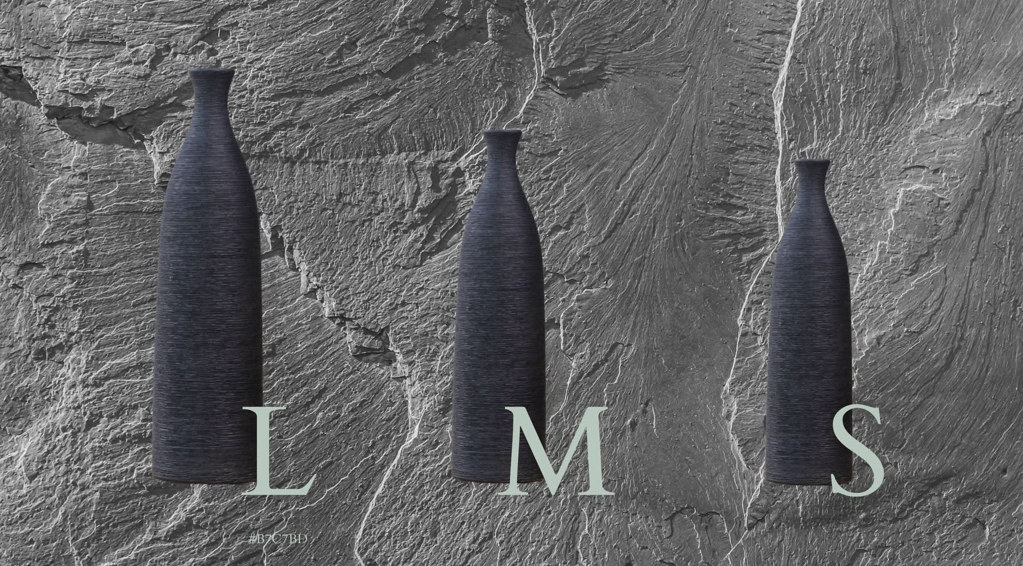 Minimalist dark grey ceramic vase in S, M, L sizes on textured background.