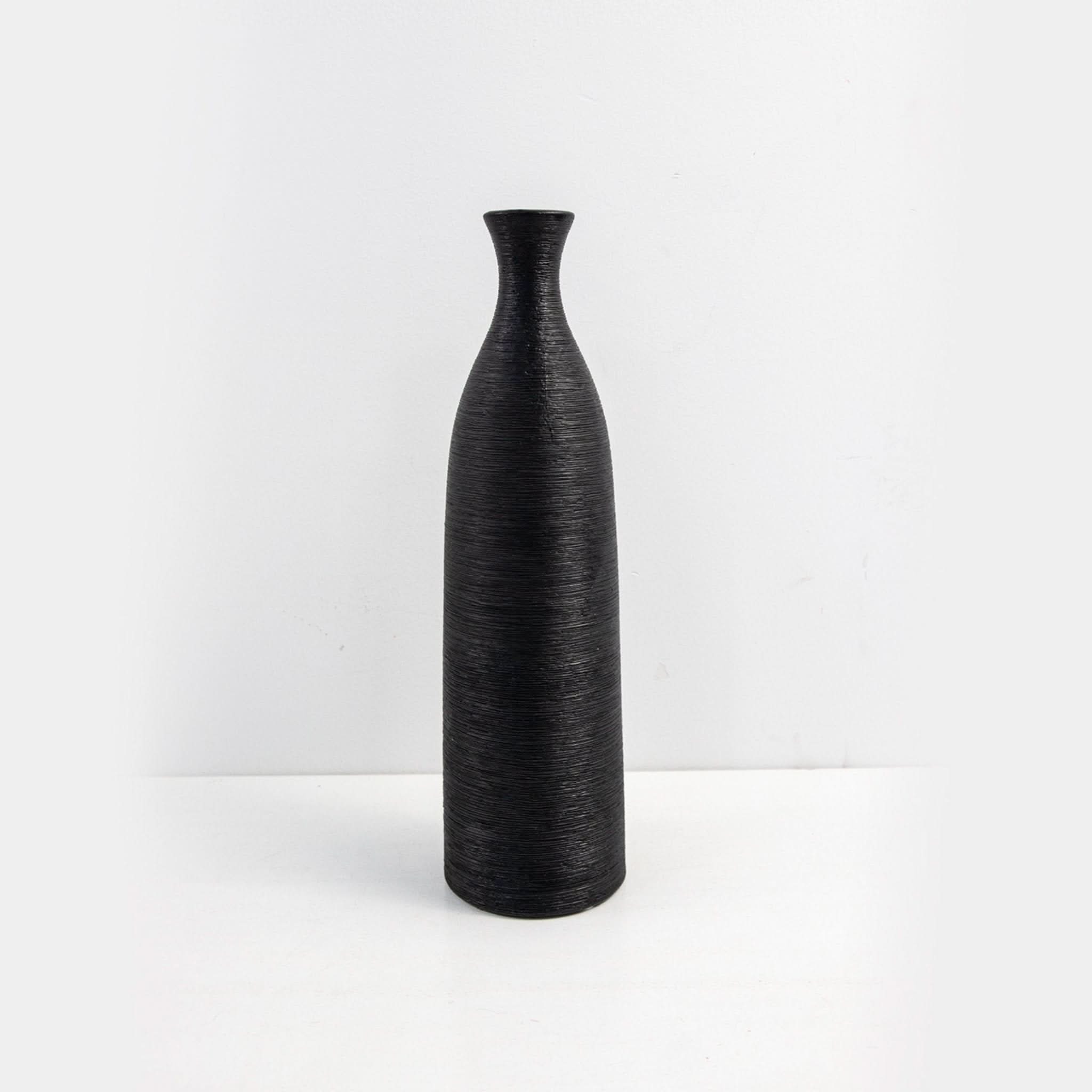 Black minimalist ceramic vase with textured finish, modern zen decor.