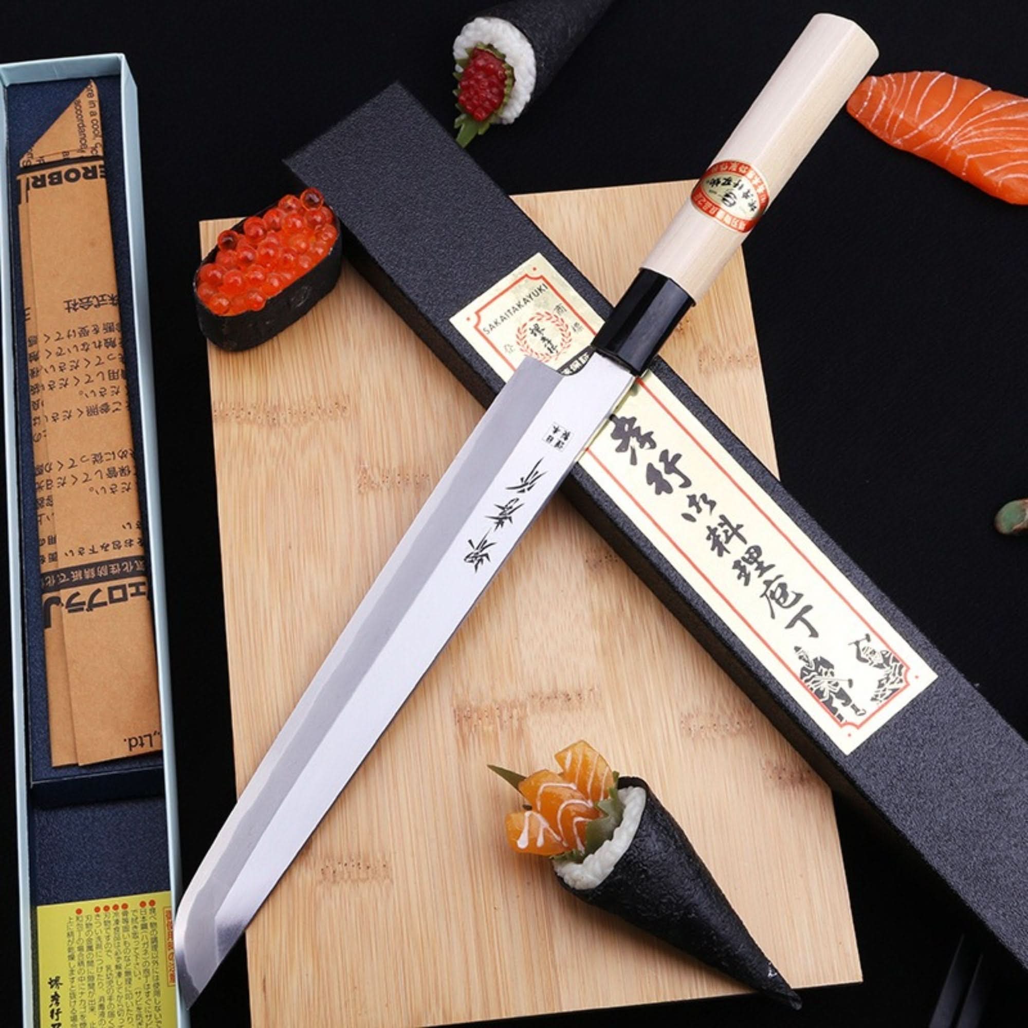Mukimono Japanese Knife made in Japan, stainless steel blade, wooden handle, on cutting board with sushi.
