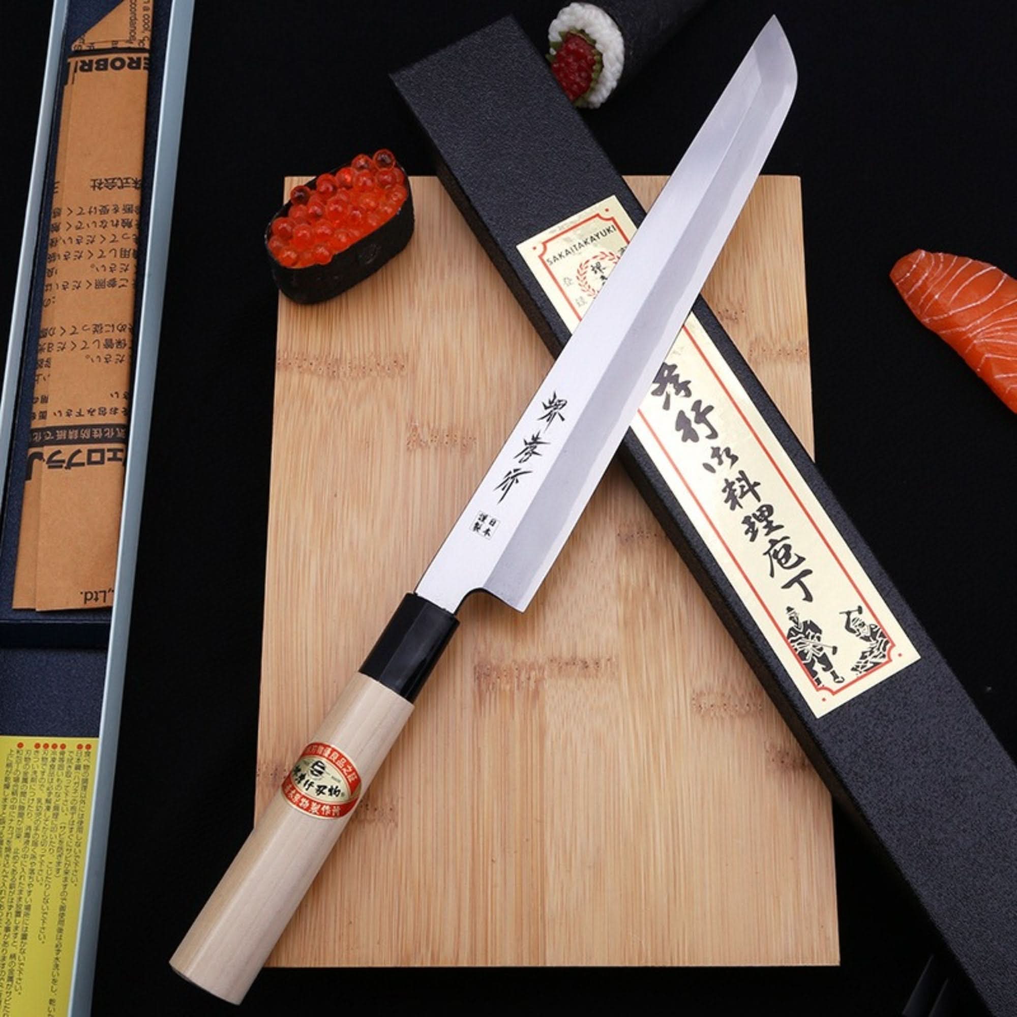 Mukimono Japanese Knife, chef knife with wooden handle on bamboo cutting board with sushi and salmon.