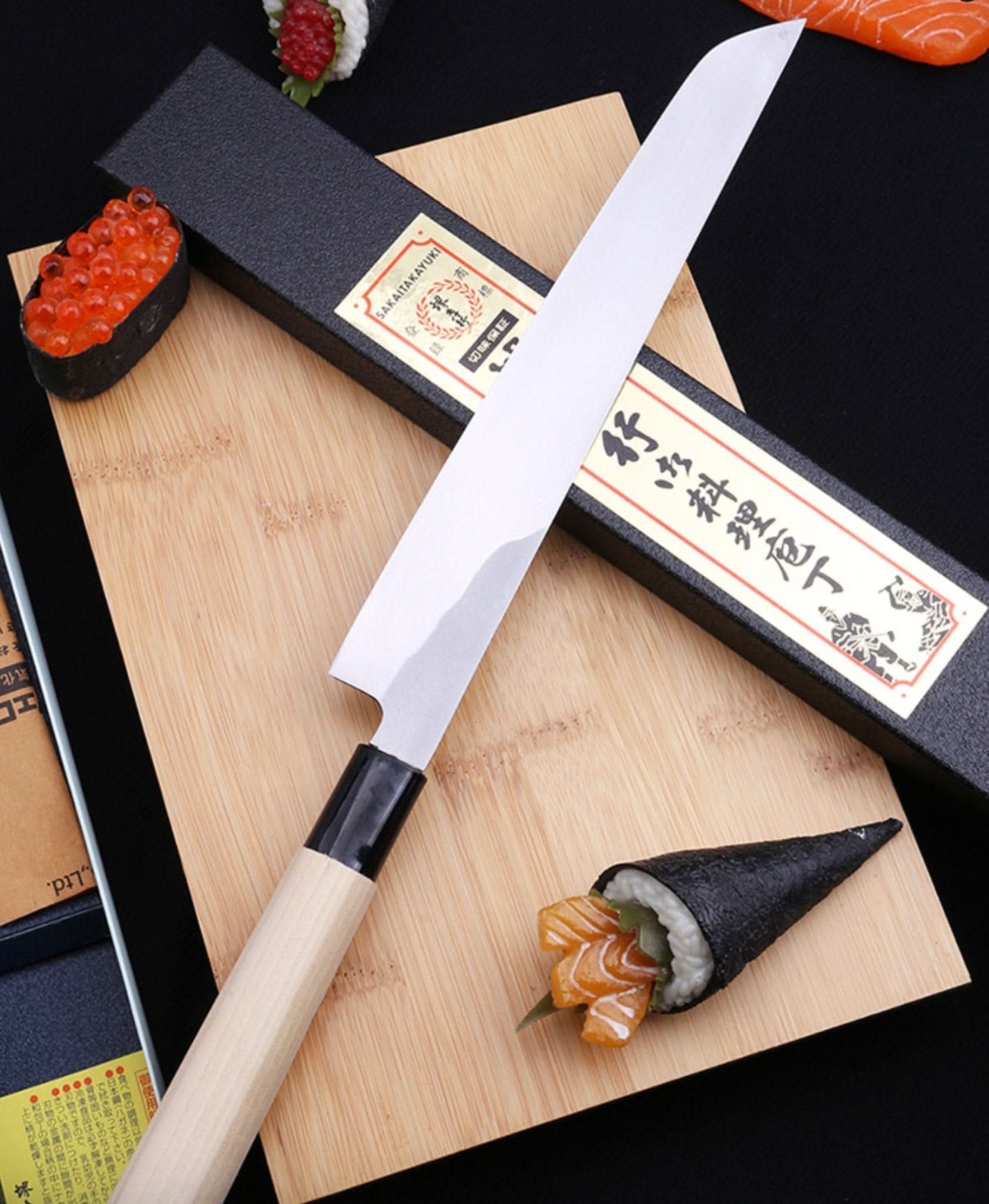 Mukimono Japanese Chef Knife, with wooden handle, on cutting board with sushi.