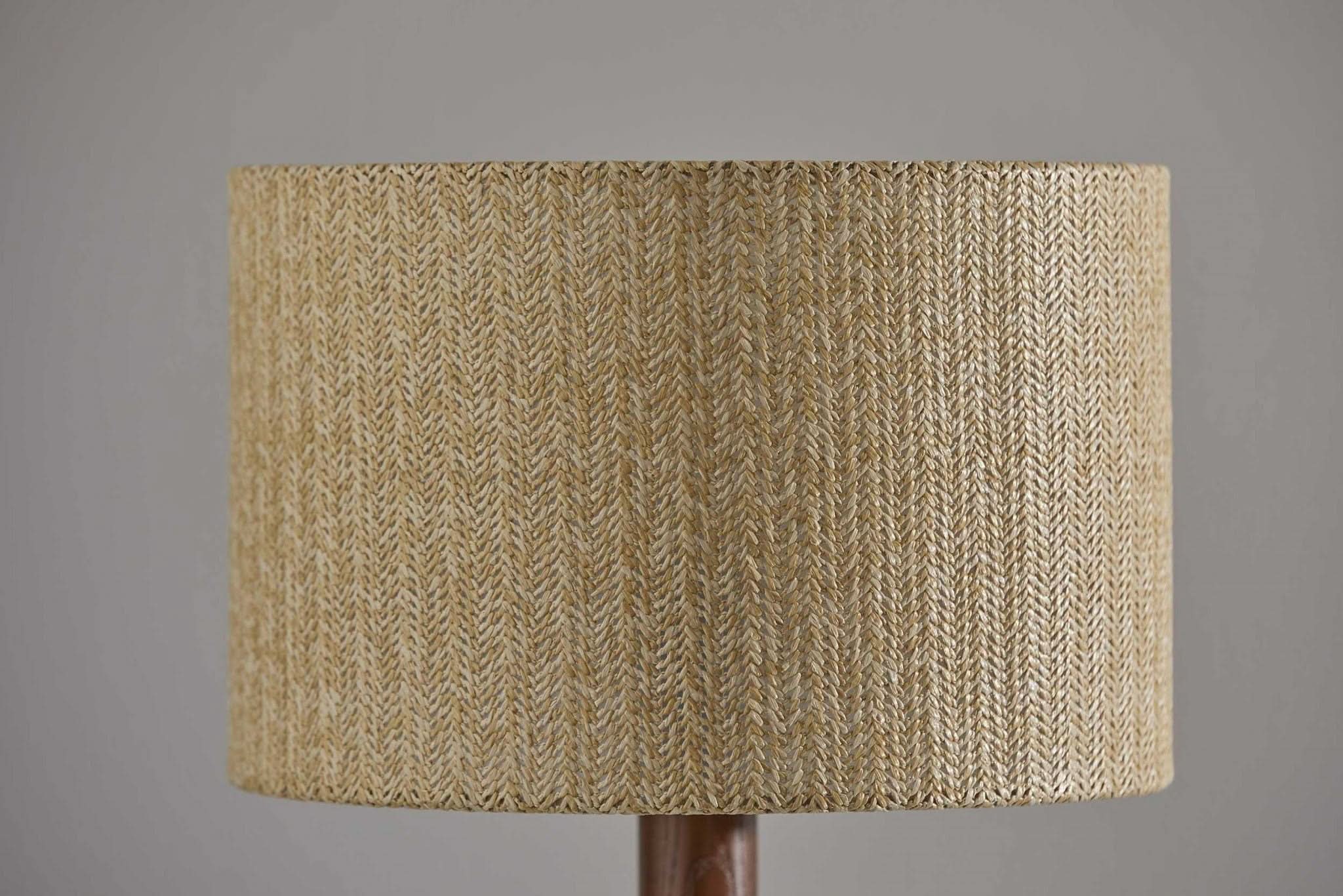 Natural wood tripod base table lamp with textured paper shade.