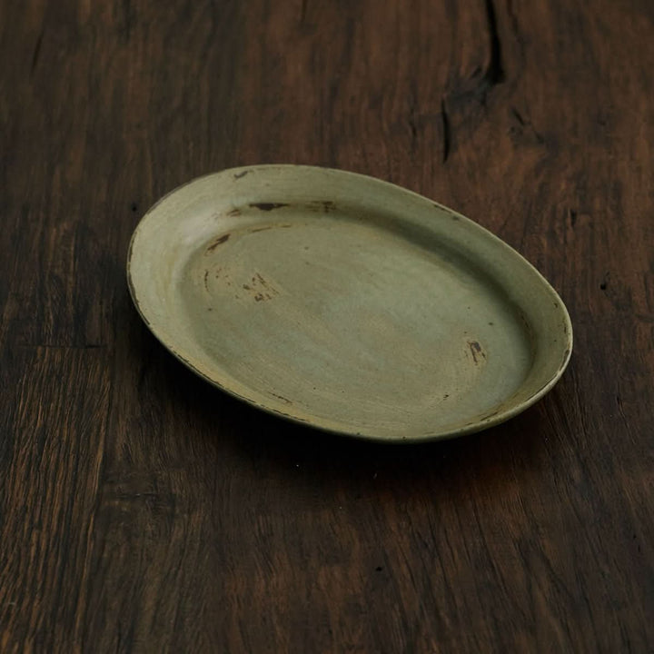 Oval, light green pottery plate, handmade, rustic.