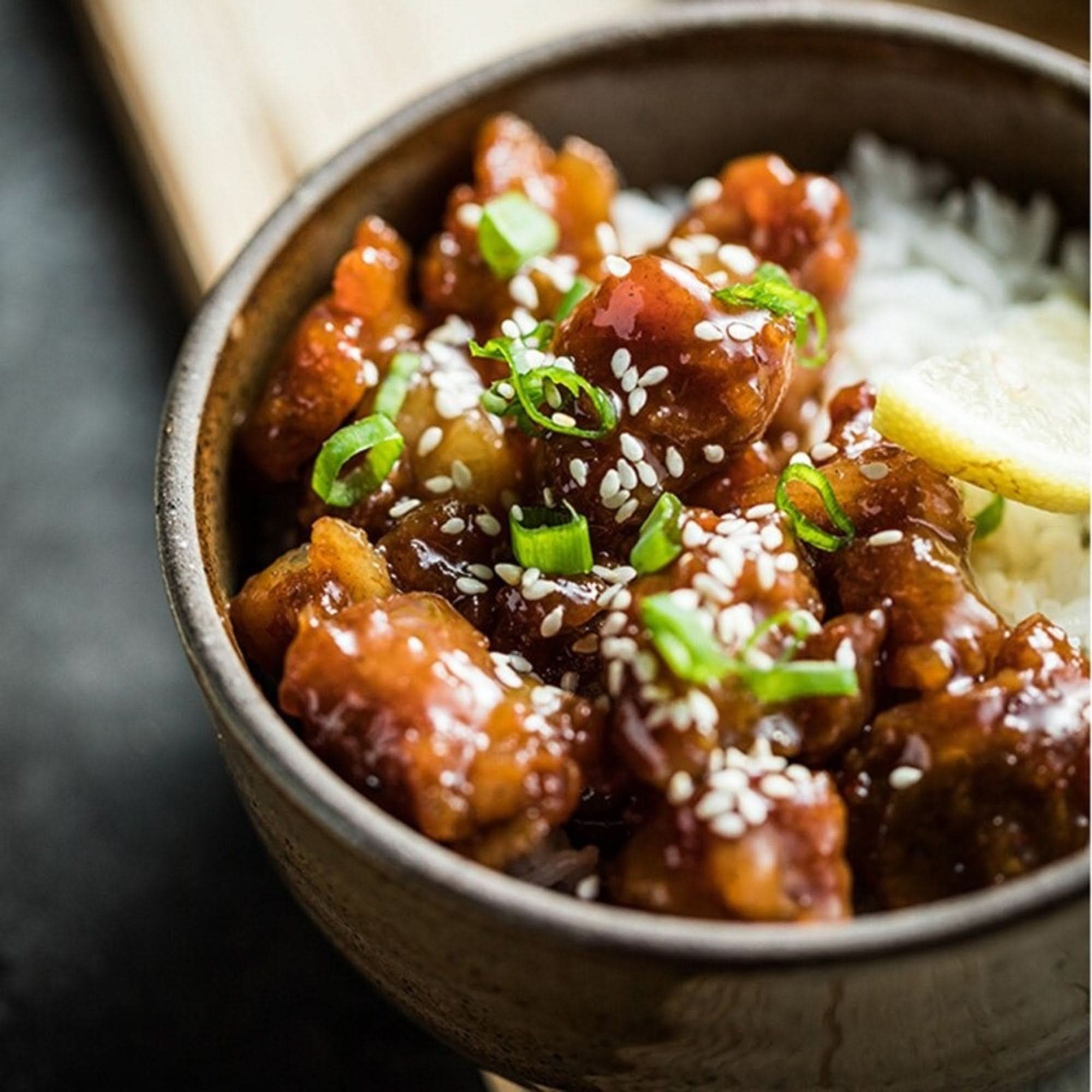 Nordic Stoneware Glazed Baking Plate holding glazed chicken, rice, and lemon slice.