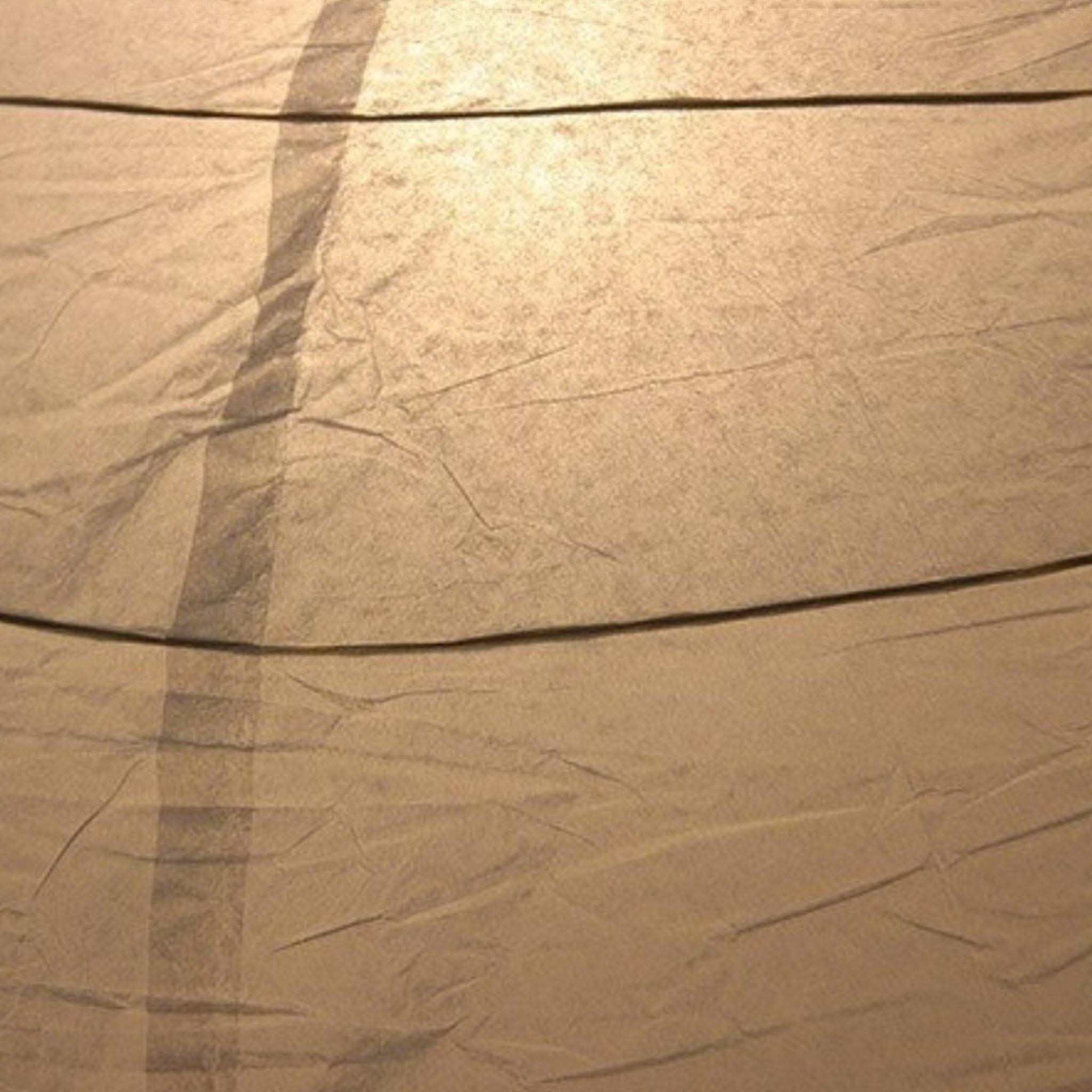 Textured beige paper lampshade, oval shape. Home decor.